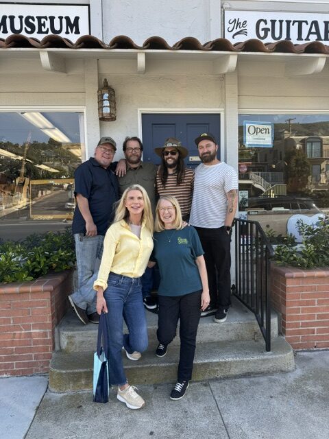 The Guitar Shoppe team with director Christina Macaulay outside the shop